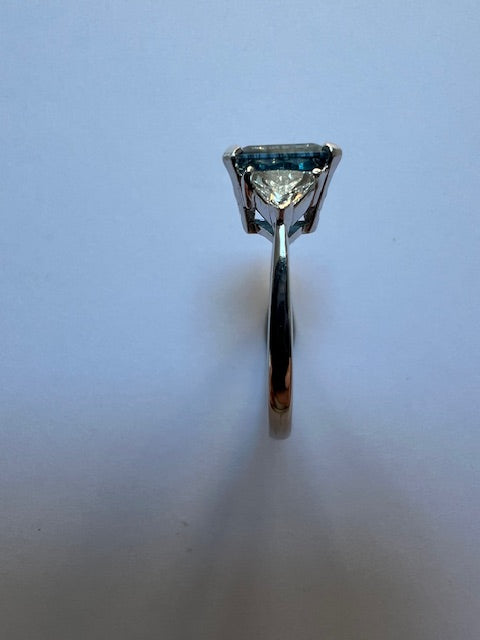 Emerald cut aquamarine and diamond three stone ring
