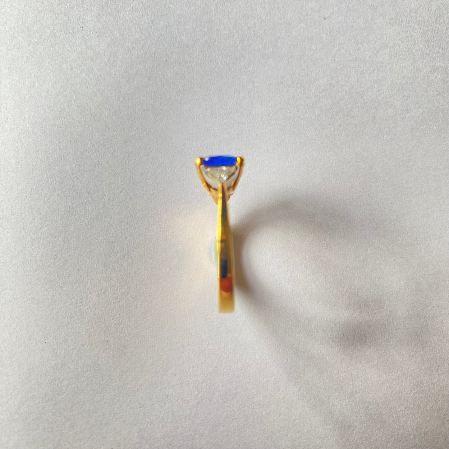 Cushion cut Ceylon sapphire and diamond three stone ring