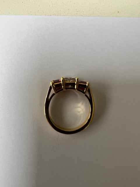 Princess cut diamond and ruby three stone ring