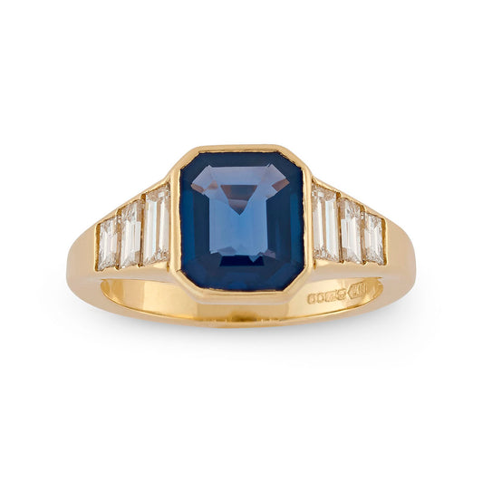 Emerald cut sapphire and baguette cut diamond engagement ring