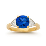 Cushion cut Ceylon sapphire and diamond three stone engagement ring