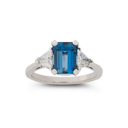 Emerald cut aquamarine and diamond three stone engagement ring