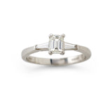 Emerald cut and tapered baguette cut diamond three stone engagement ring